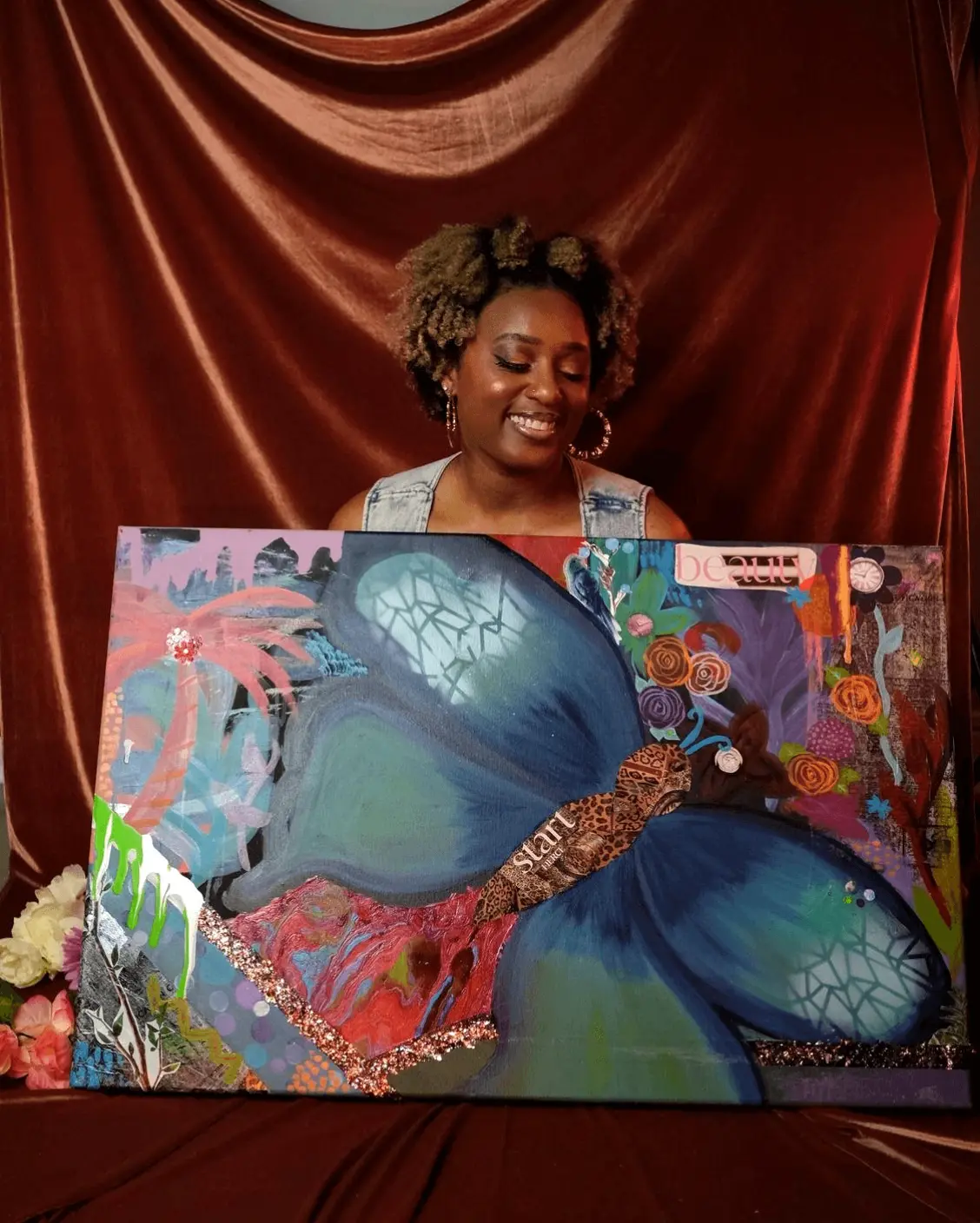 Quante' holding a large mixed media butterfly canvas